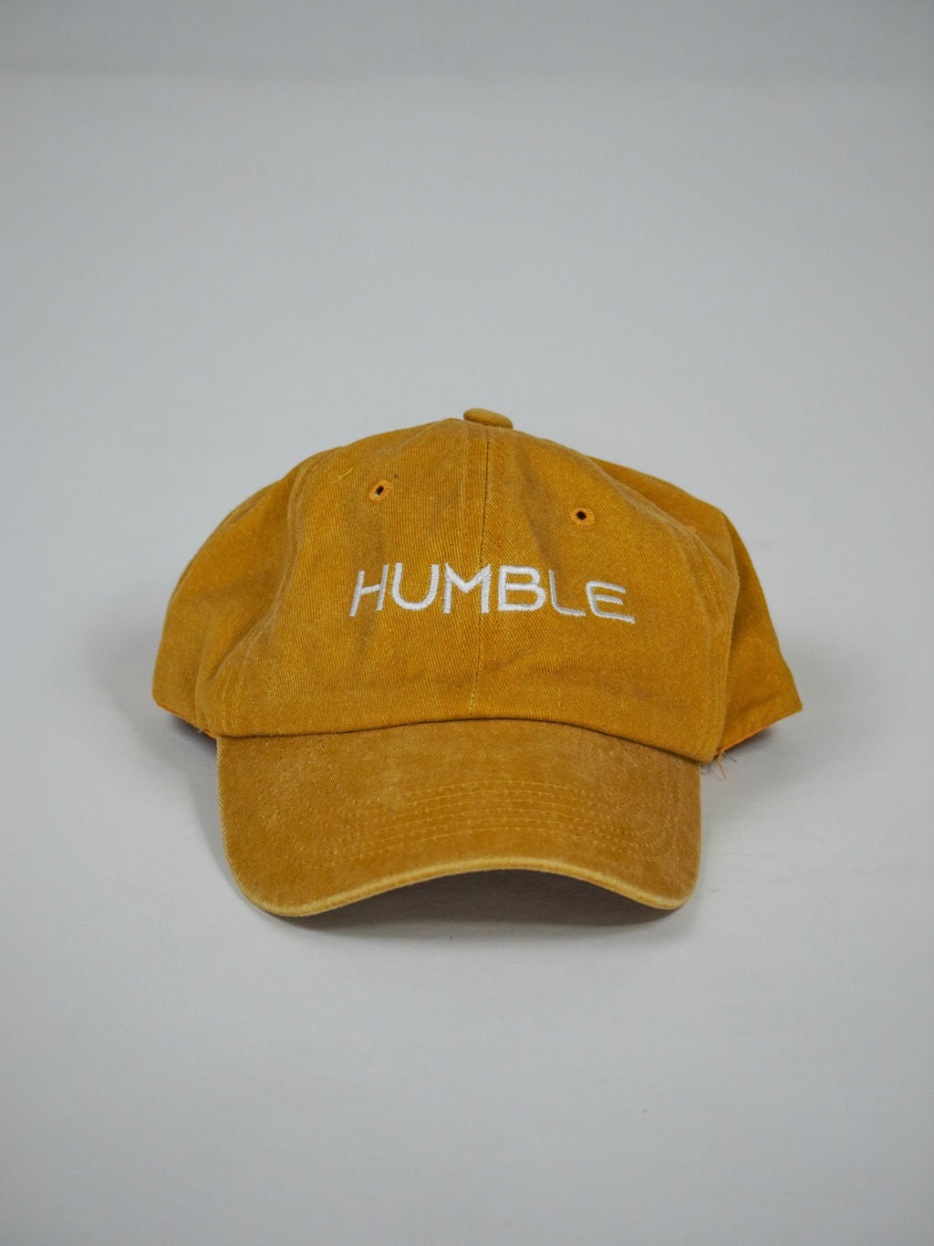 Man i guldfärgad Solid Cap från Humble Athletics